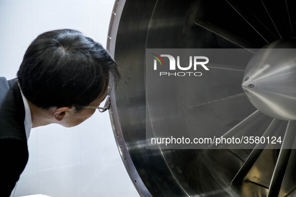 A visitor looks at turbine of an engine during Japan Aerospace 2018 air show in Tokyo, Japan, November 28, 2018. 