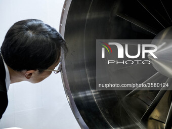 A visitor looks at turbine of an engine during Japan Aerospace 2018 air show in Tokyo, Japan, November 28, 2018. (