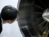 A visitor looks at turbine of an engine during Japan Aerospace 2018 air show in Tokyo, Japan, November 28, 2018. (