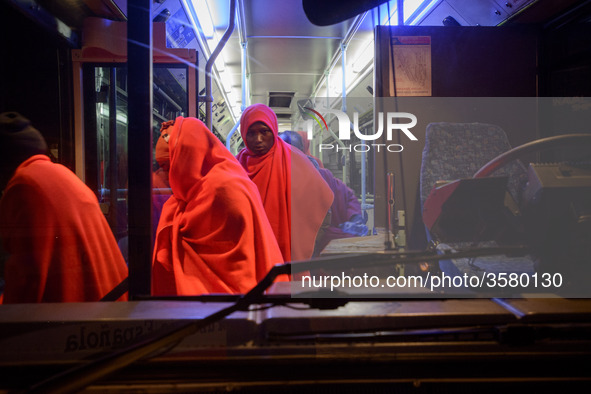 A group of rescued migrants gets off the bus to be attended by the Red cross staff inside the Care unit, at the Malaga port. 03-12-2018, Mal...