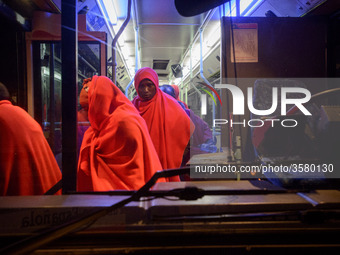 A group of rescued migrants gets off the bus to be attended by the Red cross staff inside the Care unit, at the Malaga port. 03-12-2018, Mal...