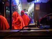 A group of rescued migrants gets off the bus to be attended by the Red cross staff inside the Care unit, at the Malaga port. 03-12-2018, Mal...