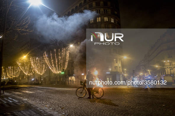 Apocalyptic scene, with a fire, the lght from an helicopter in th emiddle of the street next to the Champ-Elyssées. 08-12-2108, Paris, Franc...