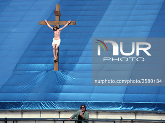 A woman and a statue of Jesus Christ are seen as during the 87th Annual Procession in honor of Our Lady of Guadalupe in Los Angeles, Califor...