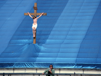 A woman and a statue of Jesus Christ are seen as during the 87th Annual Procession in honor of Our Lady of Guadalupe in Los Angeles, Califor...