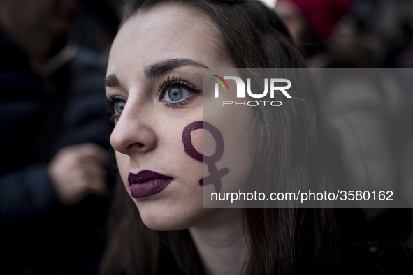 Italy, Rome: A Woman with a sign depicting the Venus symbol in her cheek  takes part in a march organised by 'Non Una Di Meno' (Me too) move...