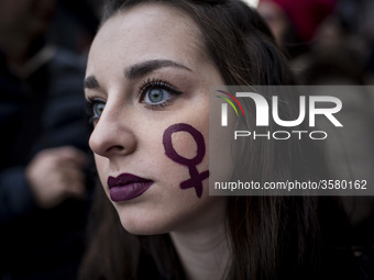 Italy, Rome: A Woman with a sign depicting the Venus symbol in her cheek  takes part in a march organised by 'Non Una Di Meno' (Me too) move...