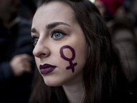 Italy, Rome: A Woman with a sign depicting the Venus symbol in her cheek  takes part in a march organised by 'Non Una Di Meno' (Me too) move...