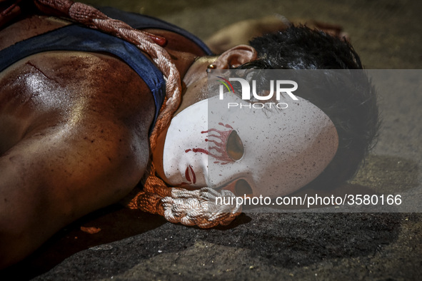 A masked flagellant lies on the ground during Good Friday Lenten rites in Navotas, Metro Manila, Philippines, March 30, 2018.

Photo: Ezra A...