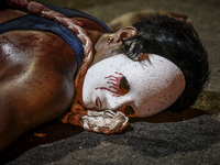 A masked flagellant lies on the ground during Good Friday Lenten rites in Navotas, Metro Manila, Philippines, March 30, 2018.

Photo: Ezra A...