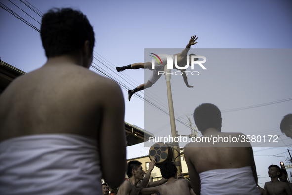 HIDA, JAPAN - APRIL 19 : Men in loincloths performs a ritual for good luck to residents during the Furukawa Festival in Hida City, Gifu pref...