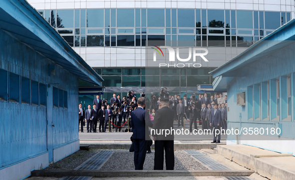 North Korean Leader Kim Jong Un and South Korean President Moon Jae-in shake hands over the military demarcation line upon meeting for the I...