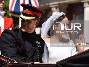 Prince Harry, Duke of Sussex and Meghan, Duchess of Sussex in the Ascot Landau carriage during the procession on The Long Walk after getting...