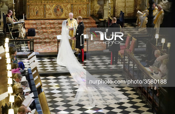 Prince Harry and Meghan Markle exchange vows in St George's Chapel at Windsor Castle during their wedding service, conducted by the Archbish...