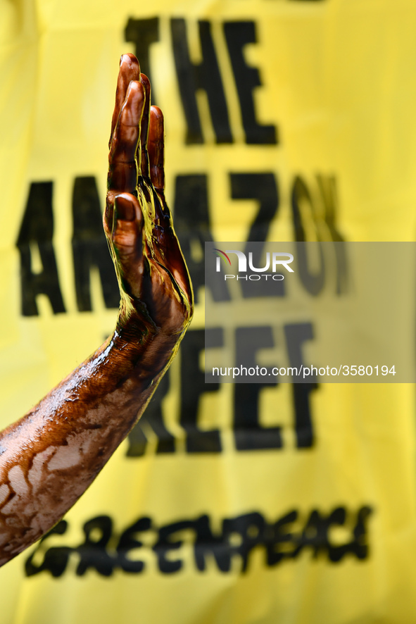 Activists of Greenpeace and Action Non Violente-COP21 stage a protest against oil exploitation in the Amazon during a general assembly of Fr...