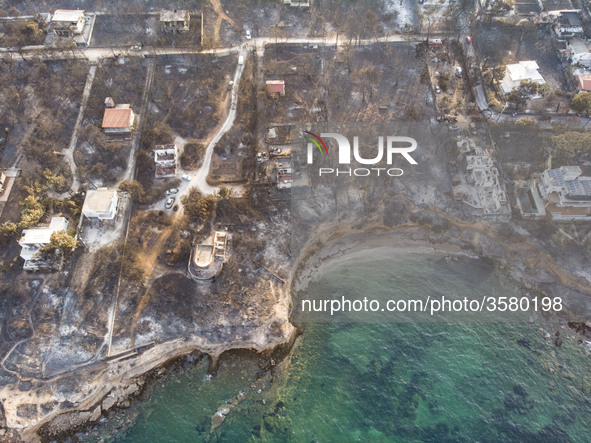 Aerial images from a drone of the devastated area of Mati in Attica, near Athens, Greece. Forest, buildings and cars are all burnt, leaving...