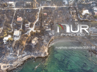 Aerial images from a drone of the devastated area of Mati in Attica, near Athens, Greece. Forest, buildings and cars are all burnt, leaving...