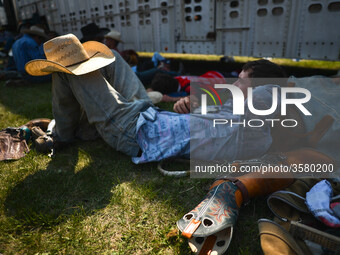 A cowboy seen resting and preparing ahead of the competition during the 105th Annual Bruce Stampede, the oldest one day rodeo in Canada. 
On...