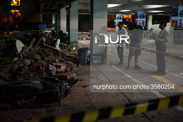 The security officers monitored the ruins of the building that hit the motorbike parking lot at Bali Galeria Mall due to the earthquake on A...