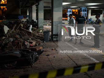 The security officers monitored the ruins of the building that hit the motorbike parking lot at Bali Galeria Mall due to the earthquake on A...