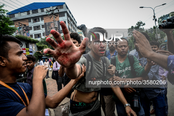 (Editor's Note: Graphic Content) A photographer is targetted during a student protest in Dhaka on August 5, 2018, following the deaths of tw...