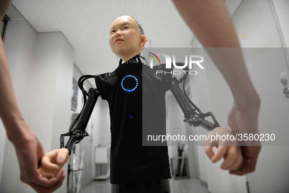 In this photo taken on September 13, 2018 shows the hand of child android robot called &quot;Ibuki&quot; with his creator during demonstrati...