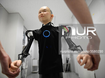 In this photo taken on September 13, 2018 shows the hand of child android robot called &quot;Ibuki&quot; with his creator during demonstrati...