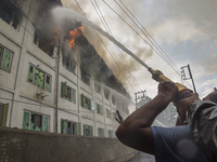 Fire fighters and volunteers try to douse flames after fire breaks out at Pamposh hotel  on September 15, 2018 in  Srinagar, the summer capi...