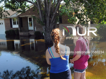 September 18, 2018 - Conway, South Carolina, United States - Kelly Arel (right) and her daughter,Victoria, look at the flood waters that sur...