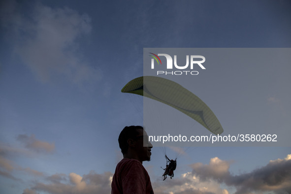 Bali, Indonesia 30 June 2018 : Despite the eruption of Mount Agung, foreign tourist still enjoying paradigling at Riug Hill - Nusa Dua - Bal...