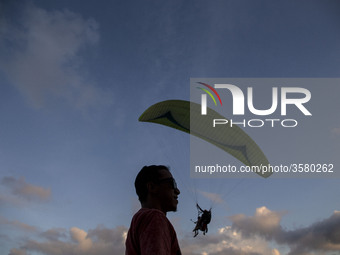 Bali, Indonesia 30 June 2018 : Despite the eruption of Mount Agung, foreign tourist still enjoying paradigling at Riug Hill - Nusa Dua - Bal...