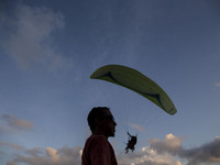 Bali, Indonesia 30 June 2018 : Despite the eruption of Mount Agung, foreign tourist still enjoying paradigling at Riug Hill - Nusa Dua - Bal...