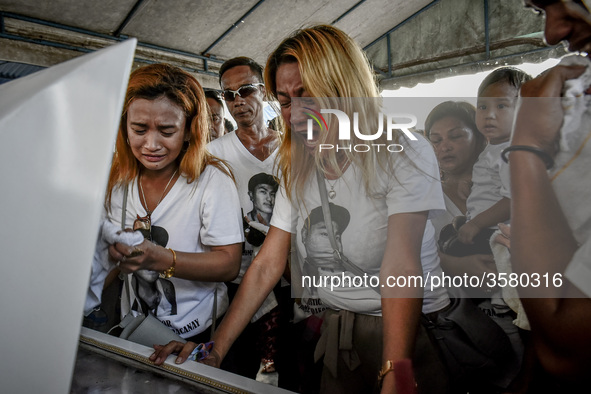 Relatives weep during the funeral of Jerome Dacanay, who was killed in a police drug sting operation, in Calumpit, Bulacan province, Philipp...