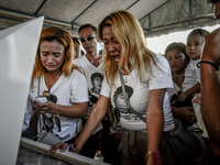 Relatives weep during the funeral of Jerome Dacanay, who was killed in a police drug sting operation, in Calumpit, Bulacan province, Philipp...