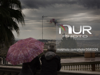 A couple watches smoke with the colors of the Italian flag  left by Air Force aerobatic unit Frecce Tricolori (Tricolor Arrows) over Rome on...