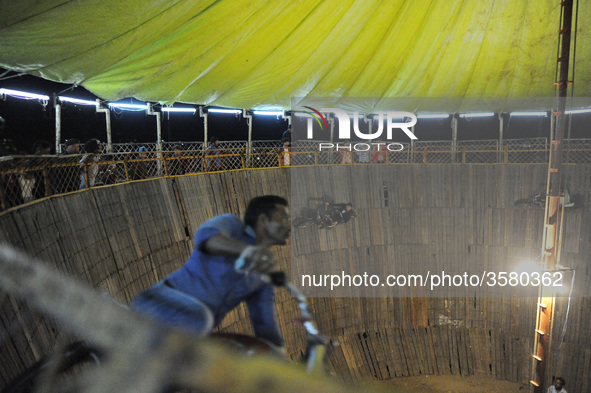 Motorcycle stuntman shows skills by riding a motorcycle inside the Well of Death during a fair in Kathmandu on Monday, October 08, 2018. 