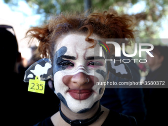 A woman with her face painted as a cow is seen during 1st March For Animal Rights in Athens, Greece on October 6, 2018 to spread the message...