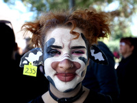 A woman with her face painted as a cow is seen during 1st March For Animal Rights in Athens, Greece on October 6, 2018 to spread the message...