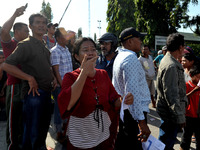 Palu residents search for families in the ruins of a house that collapsed in the recent earthquake and tsunami, near Talise Beach in Palu, C...