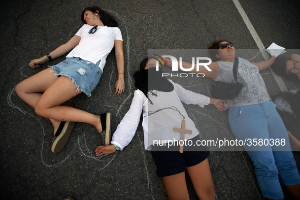 Women performed on the ground to symbolize the dead women due to a failed abortion in Argentina and elsewhere. Women and men took to the str...