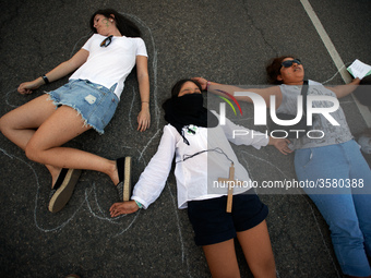 Women performed on the ground to symbolize the dead women due to a failed abortion in Argentina and elsewhere. Women and men took to the str...