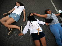 Women performed on the ground to symbolize the dead women due to a failed abortion in Argentina and elsewhere. Women and men took to the str...