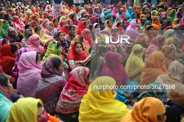 Bangladeshi garment workers block a road during a demonstration to demand higher wages, in Dhaka on January 9, 2019.  