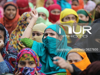 Bangladeshi garment workers shout slogans as they block a road during a demonstration to demand higher wages, in Dhaka on January 9, 2019....