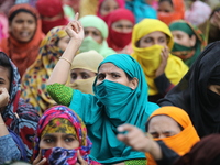 Bangladeshi garment workers shout slogans as they block a road during a demonstration to demand higher wages, in Dhaka on January 9, 2019....