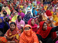 Bangladeshi garment workers shout slogans as they block a road during a demonstration to demand higher wages, in Dhaka on January 9, 2019....