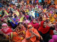 Bangladeshi garment workers shout slogans as they block a road during a demonstration to demand higher wages, in Dhaka on January 9, 2019....