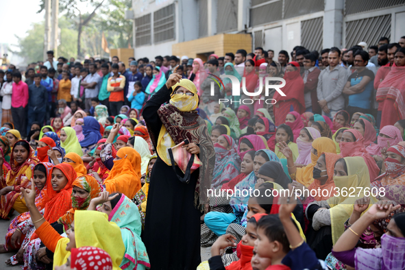 Bangladeshi garment workers shout slogans as they block a road during a demonstration to demand higher wages, in Dhaka on January 9, 2019.  