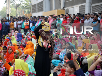 Bangladeshi garment workers shout slogans as they block a road during a demonstration to demand higher wages, in Dhaka on January 9, 2019....