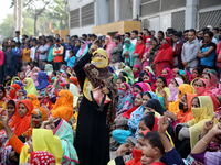 Bangladeshi garment workers shout slogans as they block a road during a demonstration to demand higher wages, in Dhaka on January 9, 2019....